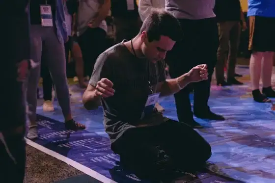 A person in worship during a YWAM conference